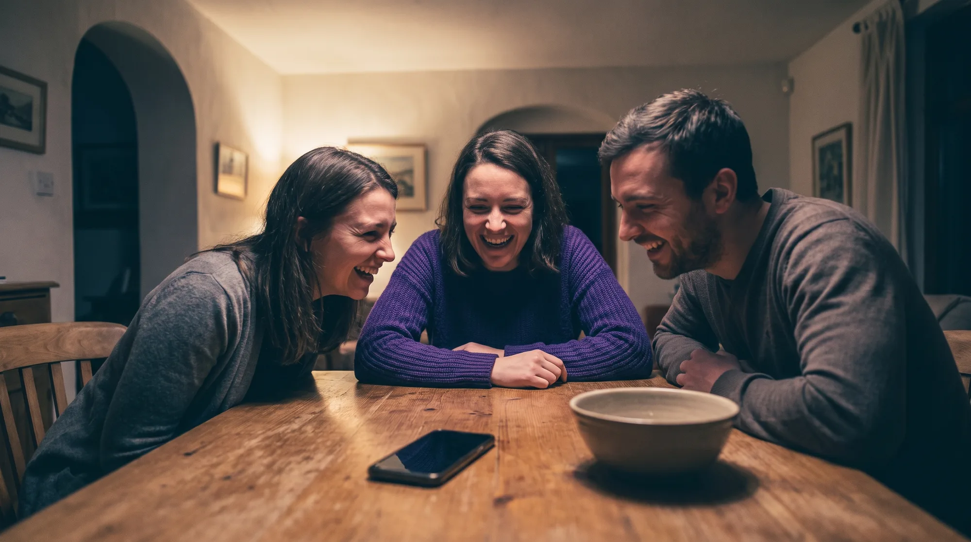 Friends sharing dinner while their phones remain out of focus